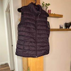 Women’s purple puffer vest and black quilted style raincoat